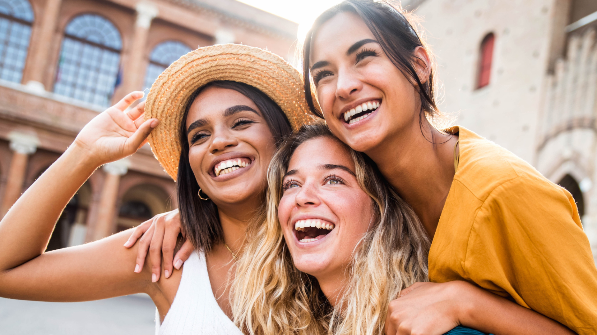 Three young women laughing together.