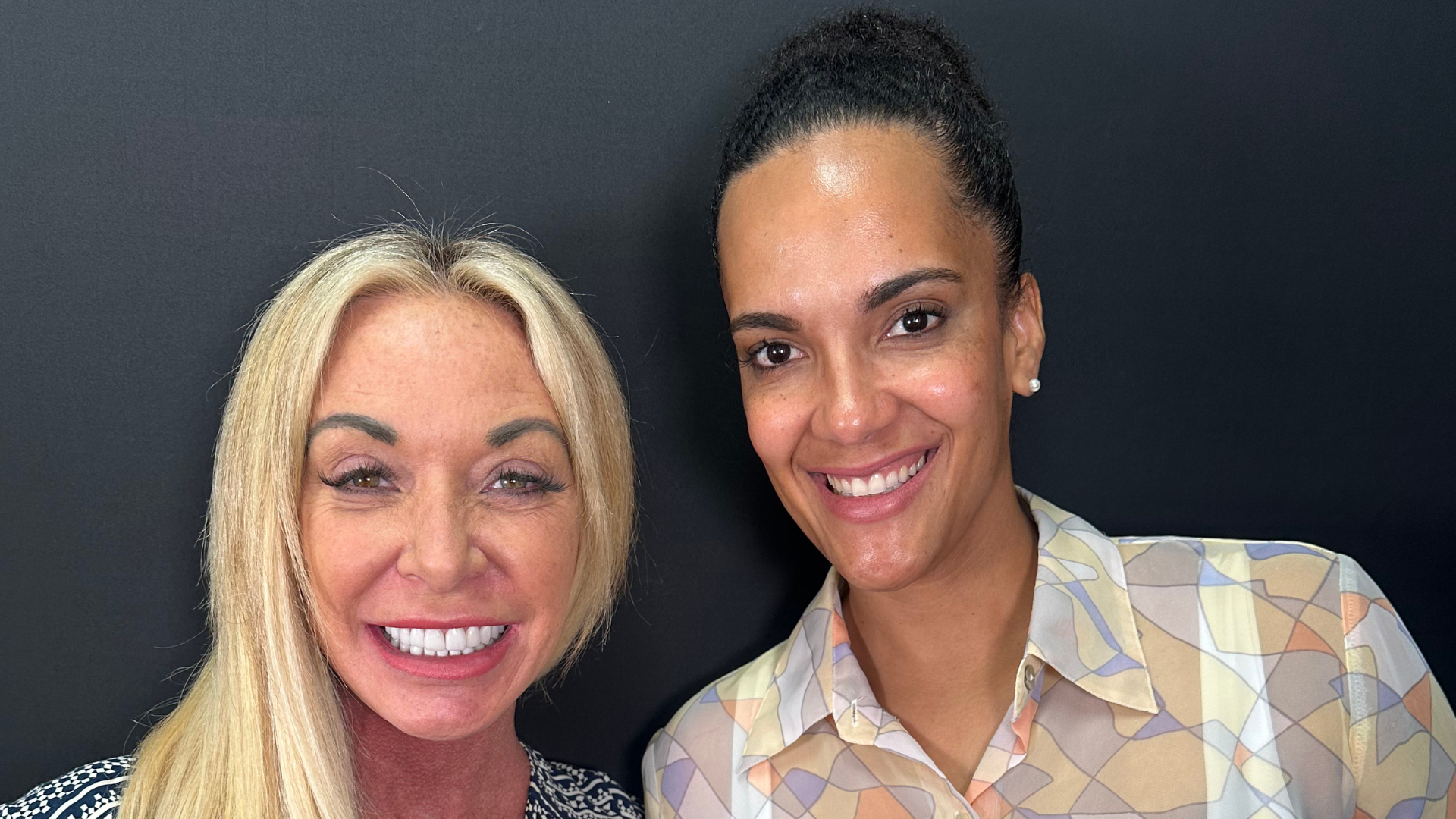 Two smiling women posing for a picture